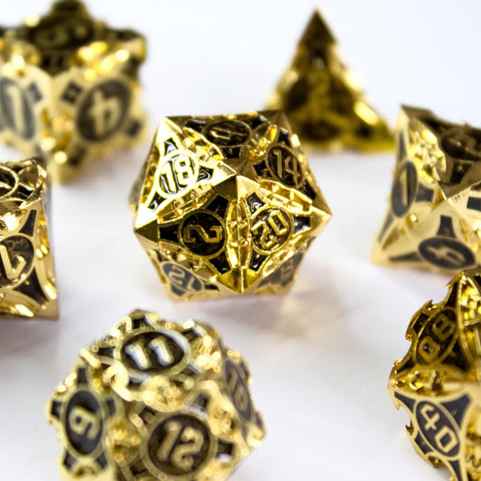 Black and gold metal polyhedral dice set for TTRPGs
